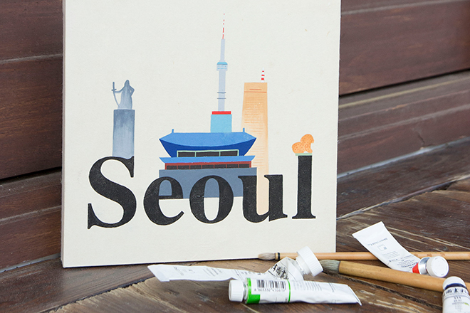 The landmarks of Seoul and Seoul letters are drawn on the canvas with paint